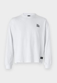 White long-sleeve shirt with a round neckline. Features a small printed text "Too many rules." in black on the upper left chest.