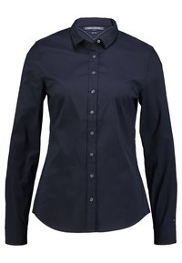 Navy long-sleeve shirt made of cotton, featuring a classic collar and button-down front, with subtle stitching detail along the collar.