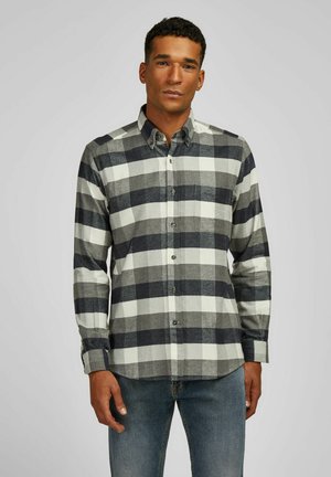 Chemise à manches longues avec boutons en motif tartan noir et gris, dotée d'un col, d'une poche avant et d'un tissu texturé.