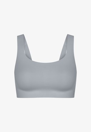 Lichtgrijze naadloze sportbeha met brede bandjes en een ronde halslijn, ontworpen voor comfort en ondersteuning.