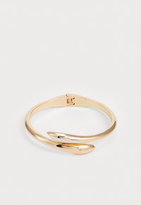 Gold-tone metal bracelet with a twisted design. Features a smooth finish and a spring closure, highlighting a sleek and modern style.