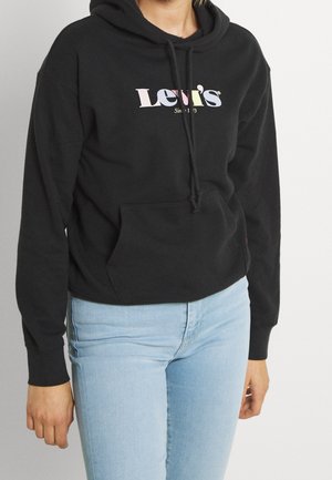 Haut à capuche noir avec cordon de serrage, arborant un logo "Levi's" multicolore. Poche kangourou à l'avant, poignets côtelés et texture douce. Assorti à un jean clair.