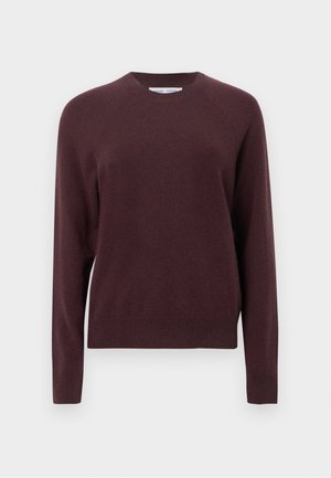 Burgunderfarget strikkegenser med rund hals, raglanermer og ribbestrikkede mansjetter og kant. Myk tekstur, avslappet design, middels vekt.