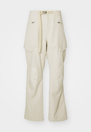 Beige cargo pants with a wide leg, belted waist, two side pockets, and knee patches. Smooth texture with reinforced stitching details.