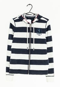 Sudadera a rayas en colores azul marino y blanco, fabricada en una mezcla de algodón, con cremallera frontal, capucha con cordón y logo bordado en el lado izquierdo del pecho.