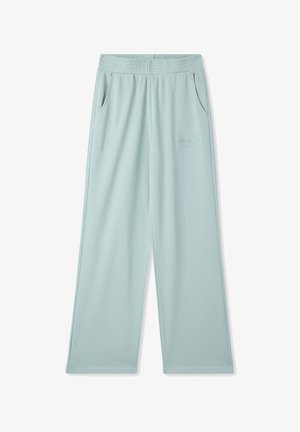 Jasnoniebieskie dżinsowe spodnie dresowe w szerokim kroju z elastycznym pasem, dwoma bocznymi kieszeniami oraz subtelnym haftowanym logo z przodu po lewej stronie.