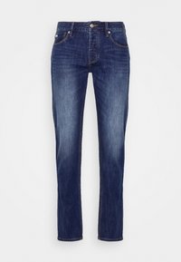 Mörkblå denimjeans med rak passform. De har knäppning med knapp, fem fickor och en ljusare blekning längs låren.