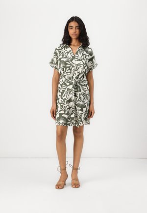 Short-sleeve, button-up dress in green and white floral print with a waist tie, knee-length, made of lightweight fabric.