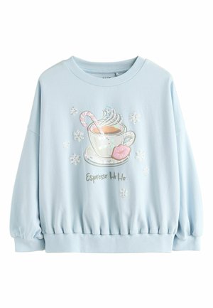 Ljusblå sweatshirt med grafisk bild av en ångande kopp, en polkagris och snöflingor. Nederkantens fåll är samlad, med mjuk textur.