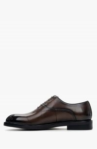Brown leather dress shoe with a rounded toe, smooth texture, five eyelet design, and a black sole. Features a polished finish.