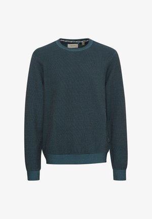 Donkerblauwe trui gemaakt van textuurgebreide stof met een ronde hals, ribgebreide manchetten en zoom. Kenmerkt zich door een contrasterend patroon aan de binnenkant van de hals.