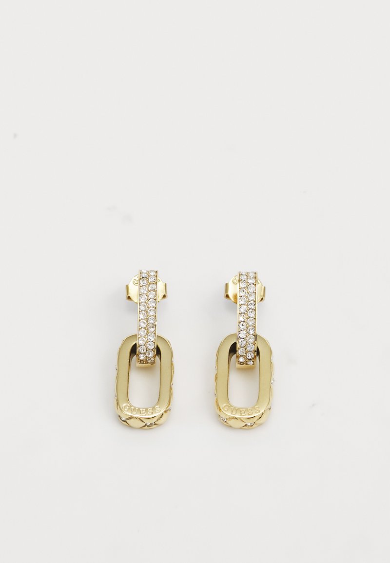 Gullfargede øredobber med en dobbeltdrop-design. Den øverste delen har en rad med klare rhinestones; den nedre delen er gravert.