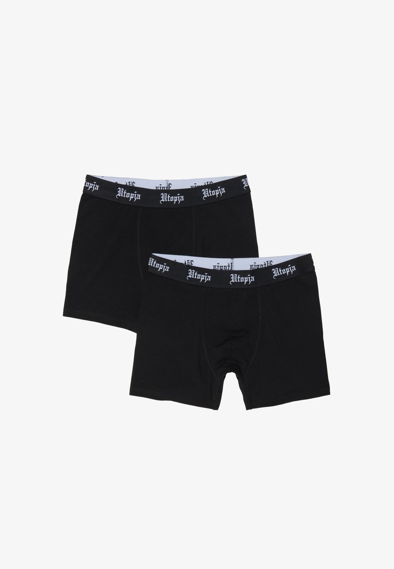 Dos pares de bóxers negros con cinturillas elásticas en blanco y negro impresas con "Utopía".