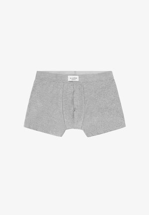 Boxer cortos grises para hombre con apertura frontal y etiqueta de la marca Scalpers en la cintura, colocados planos sobre un fondo blanco.