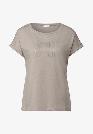 Lichtbeige, t-shirt met korte mouwen van zachte stof, met een zilveren glitterschrift met de tekst "SOFT LIGHT" in een moderne lettertype.