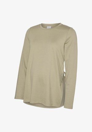 Långärmad, ljusbeige topp i mjukt material med dragsko på sidan och rundad fåll för en avslappnad passform.