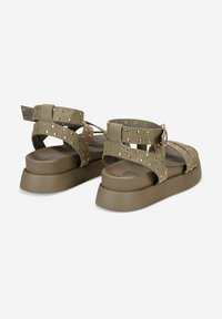 Olive green sandals with wide straps featuring gold stud accents and a chunky rubber sole, designed for comfort and support.