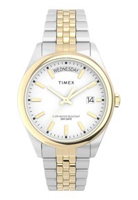 Montre-bracelet en métal argenté et doré avec un cadran blanc, index horaires dorés, affichage de la date et indication "Mercredi". Résistante à l'eau jusqu'à 50 m.