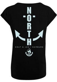 Black short-sleeve t-shirt features light blue graphic text "NORTH" with arrows and "Knut & Jan Hamburg" below. Smooth cotton texture.
