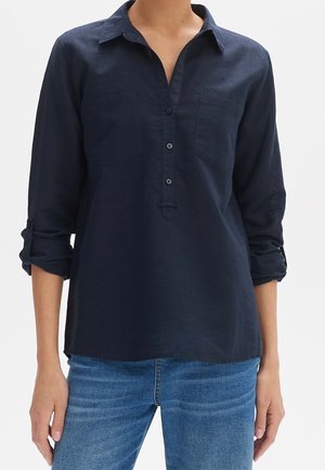 Navy blue, long-sleeve shirt with a button-up collar, two chest pockets, and rolled cuffs. Made of lightweight fabric, slightly relaxed fit.