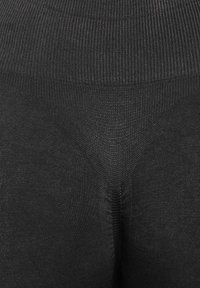 Zwarte leggings met een ribbeltextuur en naadloos ontwerp. Heeft een hoge taille en gladde stof voor comfort. Minimale details.