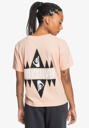 Short-sleeve, light pink cotton t-shirt featuring a large black graphic design with white "Quiksilver" text on the back, triangular accents.