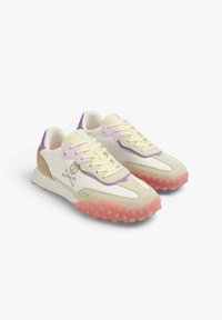 Synthetic sneakers with a white upper, purple, pink, and beige accents, textured pink sole featuring round studs, and a skull logo detail.