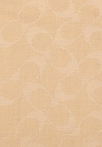 Beige fabric with a subtle embossed pattern of interlocking circles. The texture is smooth with a soft, woven appearance.