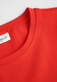 Czerwona bawełniana koszulka z okrągłym dekoltem i krótkimi rękawami. Gładka tekstura z widoczną metką z napisem "Grillo" oraz rozmiarem "10Y".