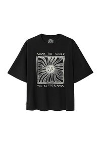Black organic cotton t-shirt with short sleeves. Features a graphic design of a sun in the center, surrounded by text and decorative lines.