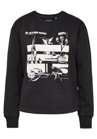 Sweatshirt noir en coton avec un imprimé graphique blanc de plantes et de fleurs, col rond, manches longues et poignets côtelés.
