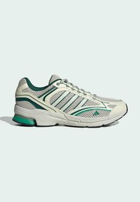 Lightweight athletic shoe with mesh upper, green and white color scheme, prominent stripes, padded collar, and textured outsole.
