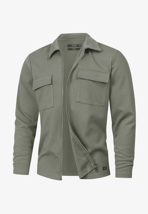 Olijfgroene jas met rits, gemaakt van een katoenmengsel, met een kraag, lange mouwen en twee borstzakken aan de voorkant. Getextureerde stof.