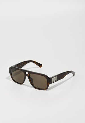 Tortoiseshell sunglasses with square frames, brown tinted lenses, and a metallic accent on the side. Smooth plastic material.