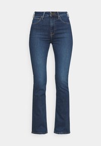 Dunkelblaue Schlagjeans aus Denim, mit hohem Bund, Fünf-Taschen-Design und kontrastierenden Nähten entlang der Nähte.