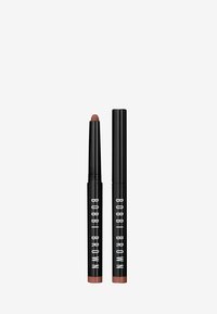 Bobbi Brown läpppenna i svart hölje, med en rundad, matt nude spets. Kompakt design med fet vit logotyp och slät, mjuk yta.