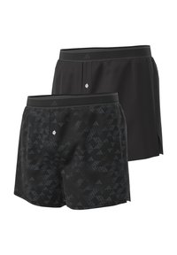Pantaloni sportivi neri con una texture liscia, caratterizzati da un sottile motivo geometrico in un paio, che contrasta con un secondo paio completamente nero.
