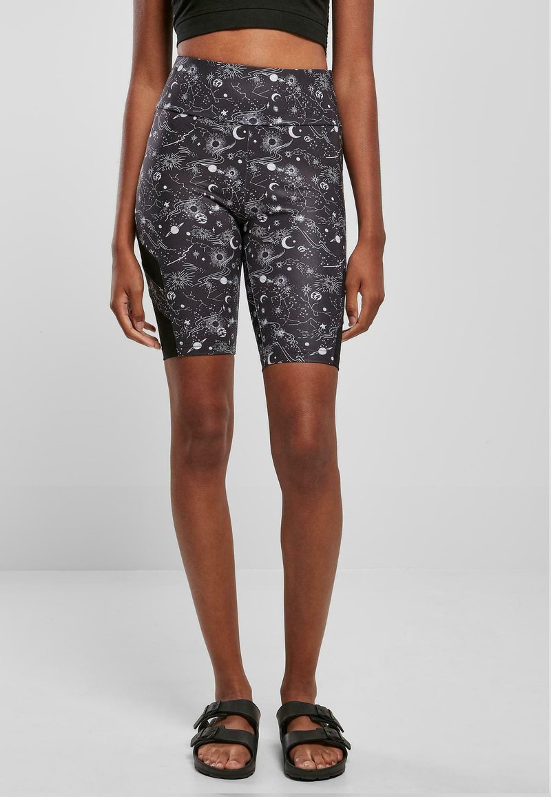 Zwarte fiets shorts met een wit sterrenbeeldpatroon van manen en sterren, gemaakt van rekbaar materiaal. Hoge taille ontwerp.