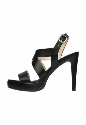 Sandal con tacco alto in pelle nera e piattaforma, caratterizzata da cinturini incrociati, punta aperta e fibbia regolabile alla caviglia. Texture liscia.