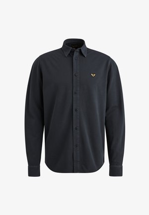 Camicia a maniche lunghe blu scuro con colletto button-down, bottoni frontali e un piccolo emblema dorato sul petto sinistro. Tessuto dal tocco morbido.