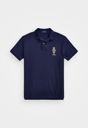 Marineblauw poloshirt van katoen, met een kraag met drie knopen, korte mouwen en een geborduurd berenlogo met "POLO."