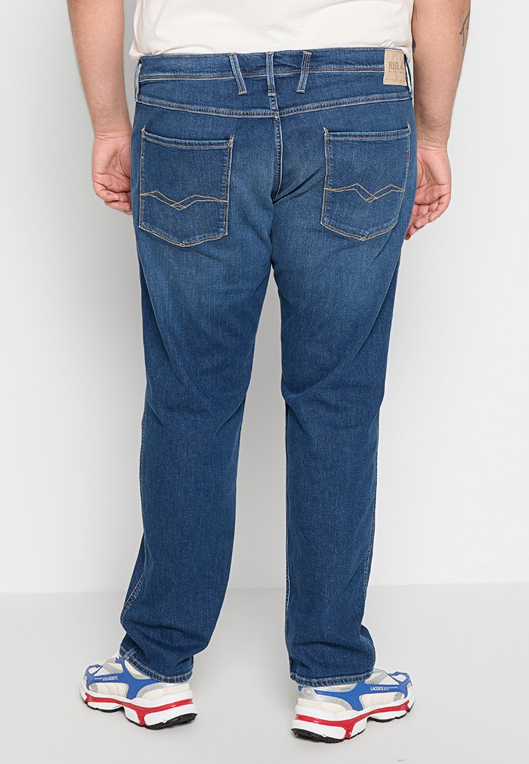 Blauwe denim jeans met een recht ontwerp, voorzien van twee achterzakken met decoratieve stiksels en een tan merklabel op de tailleband.