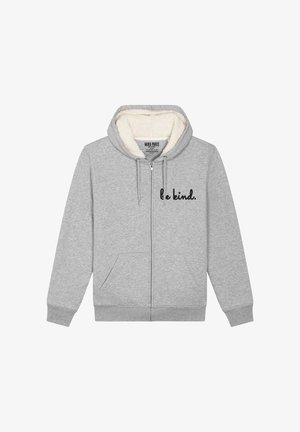 Felpa grigia con zip realizzata in un morbido tessuto con interni foderati in pile. Presenta due tasche laterali e la scritta "sii gentile" stampata in nero sul davanti.