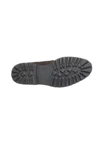 Black rubber shoe sole with deep grooves and ridges for traction; a flat surface with a reinforced heel area and minimal padding.