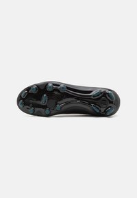 Black athletic shoe sole with a smooth surface and multiple rounded studs. Features teal accents around the studs for traction.