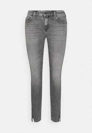 Jeans grigi slim-fit in denim, caratterizzati da un leggero sbiadimento, tasche frontali e dettagli con zip alla caviglia.