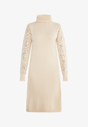 Knit dress in soft beige with a high collar and long sleeves. Sleeves feature a pattern of gold sequins. Straight cut.