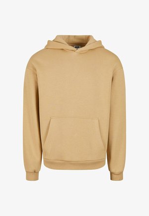 Beige huppari, joka on valmistettu pehmeästä kankaasta, sisältää kengurupocketin, ribbetyt hihanpäät ja rento istuvuus.