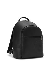 Black leather backpack with front zip pocket, embossed circular logo, padded straps, top handle, and sleek minimalist design.