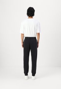 Hollister Co. Relaxed Fleece Joggers - Tracksuit bottoms - black beauty